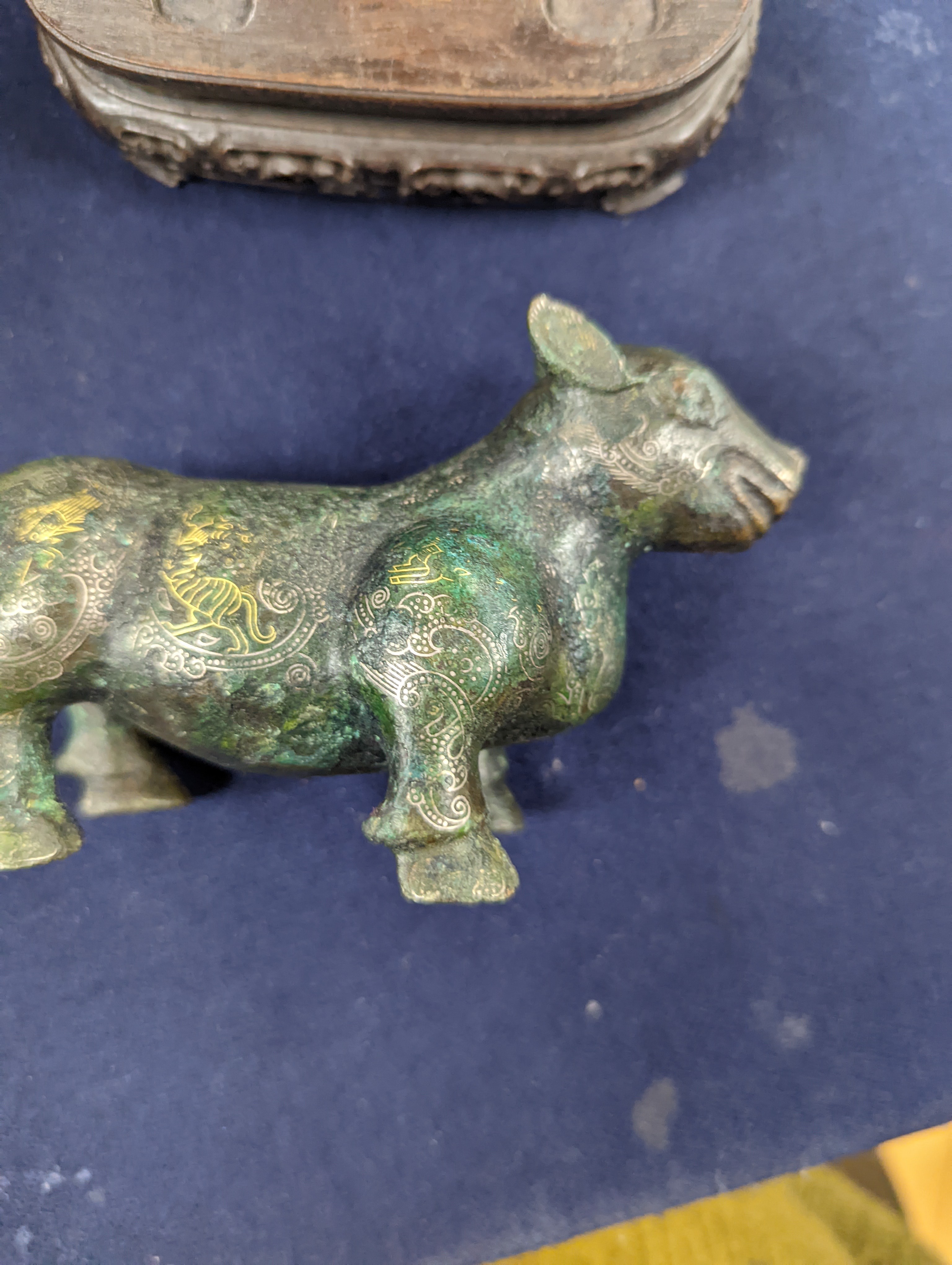 A Chinese gold and silver inlaid bronze figure of a tapir, Han dynasty or later, L. 12cm, excluding hardwood stand and fitted box